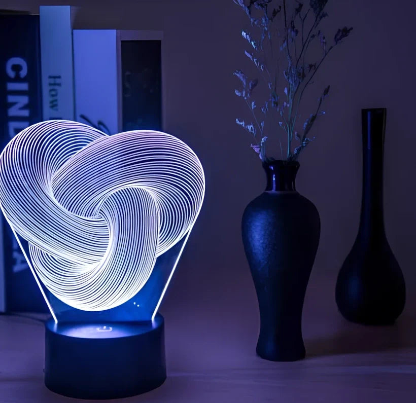 Twist abstract LED 3D night light with acrylic construction showing colour gradient illumination on dark surface