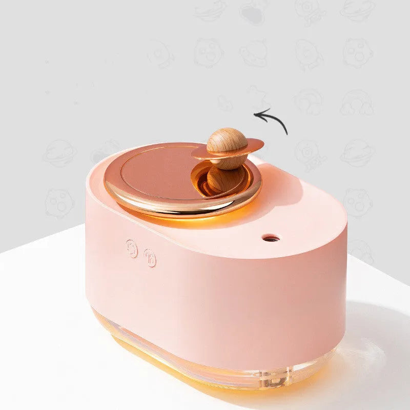 Rotating planet-shaped humidifier in green colour with USB cable and mist emitting from the top.