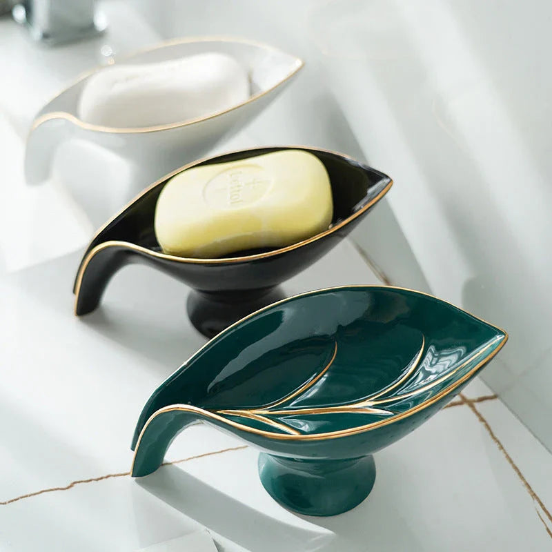 Elegant ceramic soap dish with leaf-shaped design, suction cup, and drainage holes for bathroom and kitchen use