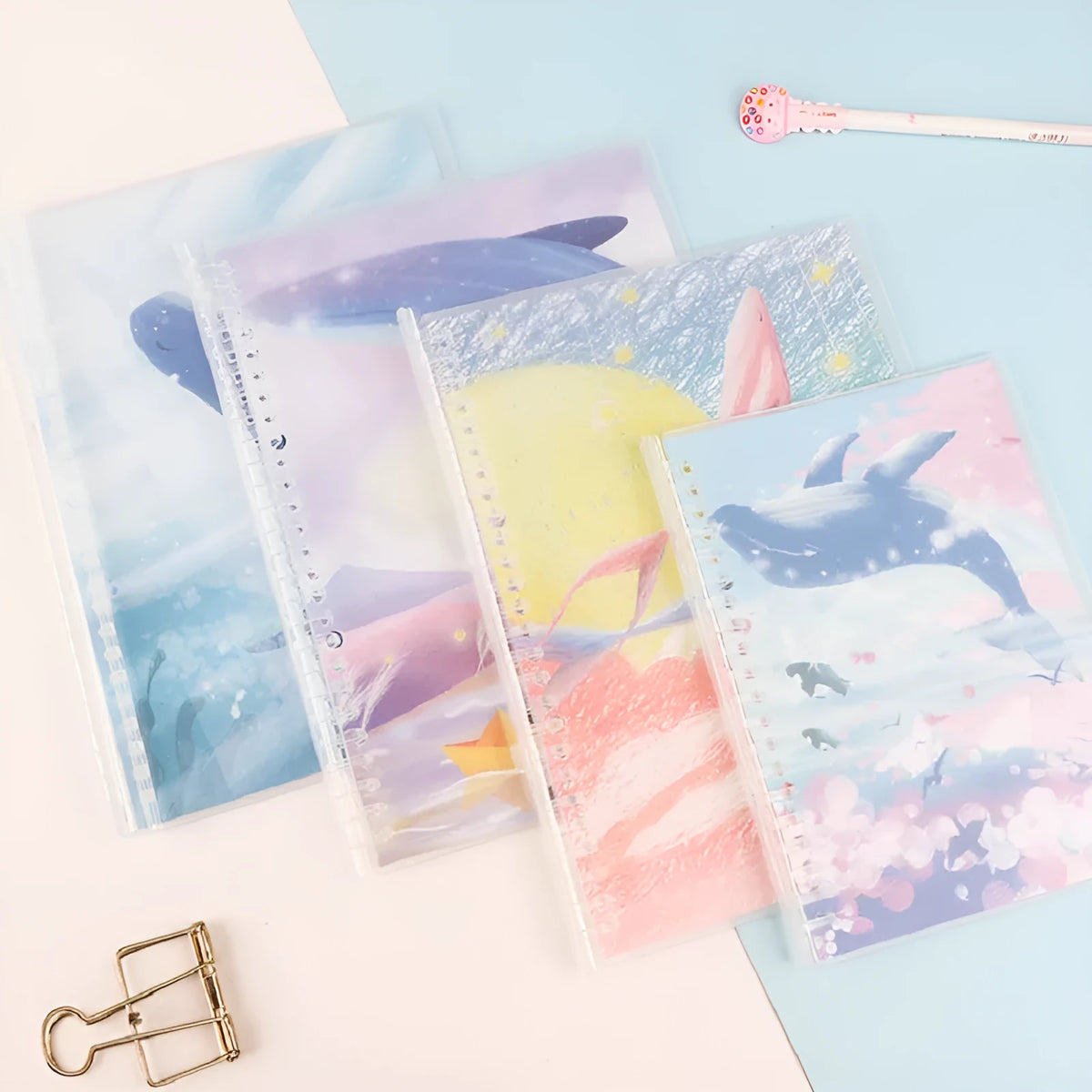 Hard cover A5 and B5 notebook with animal painting designs like whales and fruit, showing coil binding.