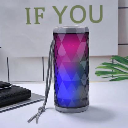 Portable Bluetooth speaker with dual 5W drivers, LED light, available in blue, green, grey and red.