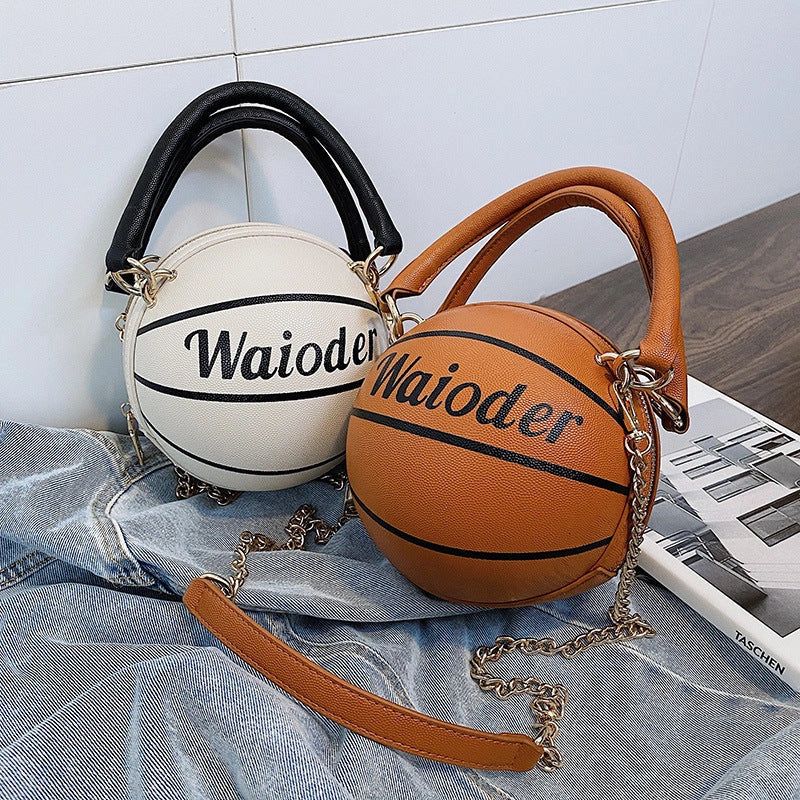 Basketball-shaped handbag with adjustable shoulder strap in pink, white, black, and brown