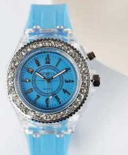 Women's LED luminous quartz watch with silicone strap and round alloy case on wrist