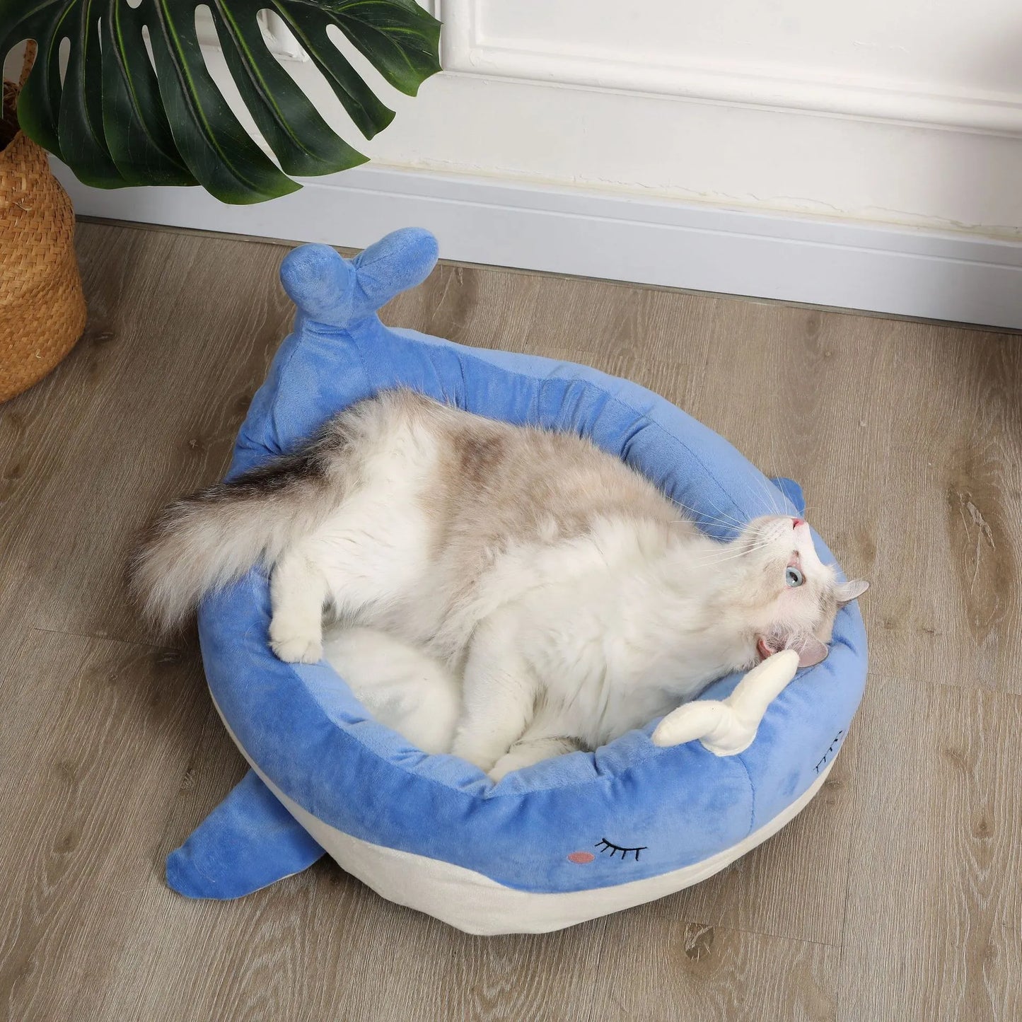Blue duck shape fluffy pet bed sofa for small dogs and cats on a wooden floor