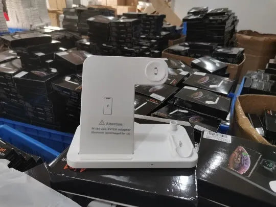 Black folding 4-in-1 wireless charger open, showing iPhone, Apple Watch, AirPods, and Apple Pen charging simultaneously.
