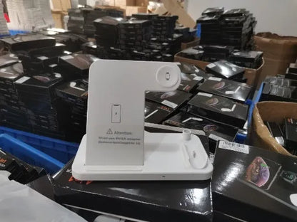 Black folding 4-in-1 wireless charger open, showing iPhone, Apple Watch, AirPods, and Apple Pen charging simultaneously.