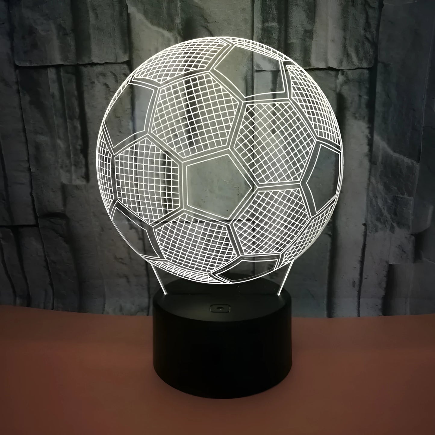 3D football-shaped LED night light showing colourful gradient illumination on a dark background