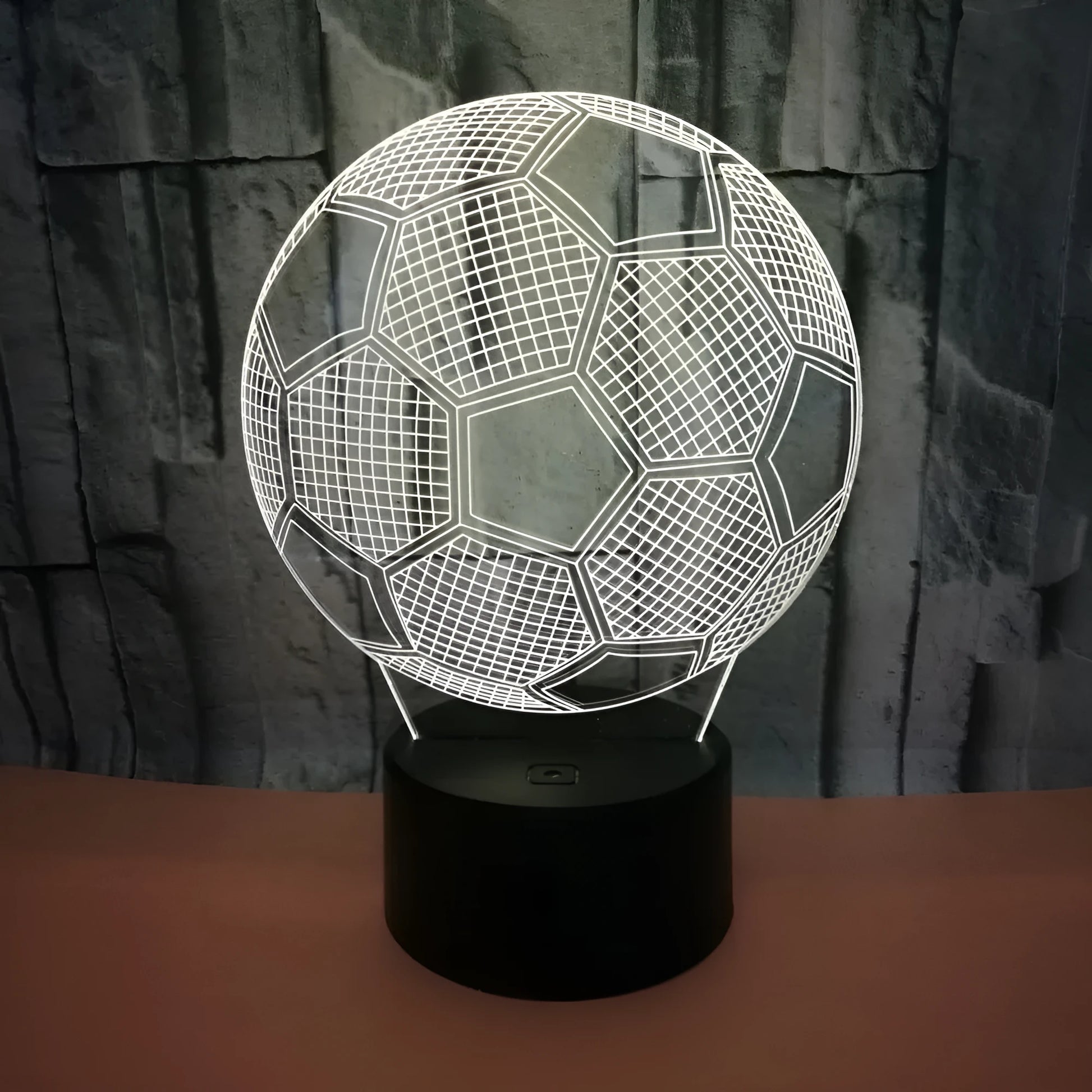 3D football-shaped LED night light showing colourful gradient illumination on a dark background
