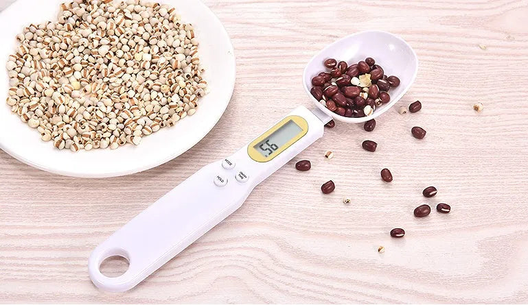 Black electronic measuring spoon scale showing digital display with spoon bowl for kitchen weighing