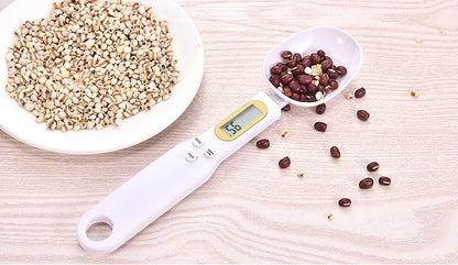 Black electronic measuring spoon scale showing digital display with spoon bowl for kitchen weighing