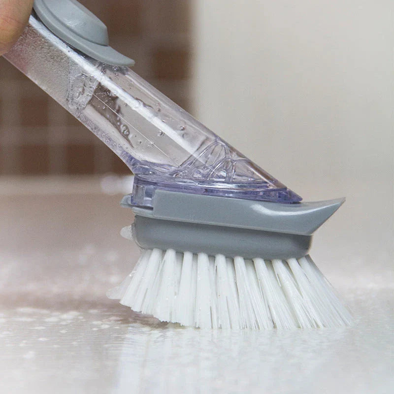 Long-handled kitchen cleaning brush with removable head, designed for efficient and hygienic scrubbing of dishes, bowls, and surfaces.