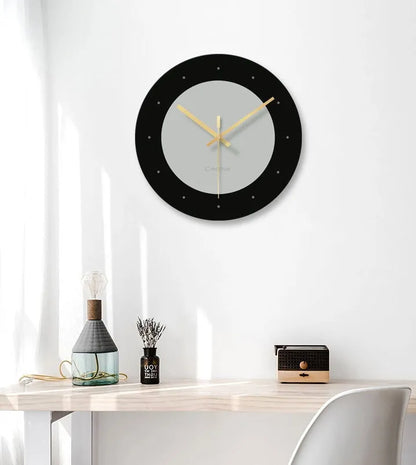 A large, clear tempered glass wall clock with a minimalist transparent face on a light background.