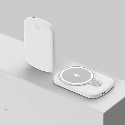 Magsafe magnetic wireless power bank in black, attached to an iPhone.