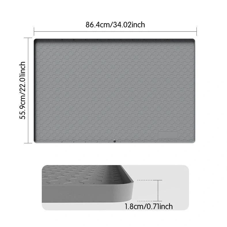 Grey silicone sink mat measuring 864mm by 558mm protecting kitchen cabinet from water damage
