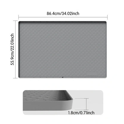 Grey silicone sink mat measuring 864mm by 558mm protecting kitchen cabinet from water damage