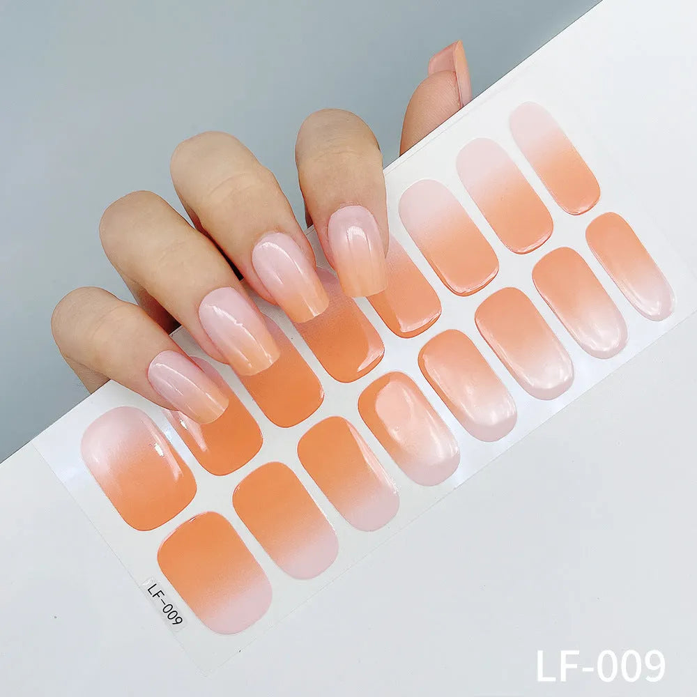 Sheet of 16 small design nail art stickers including cross, rose, tulip and marble patterns.