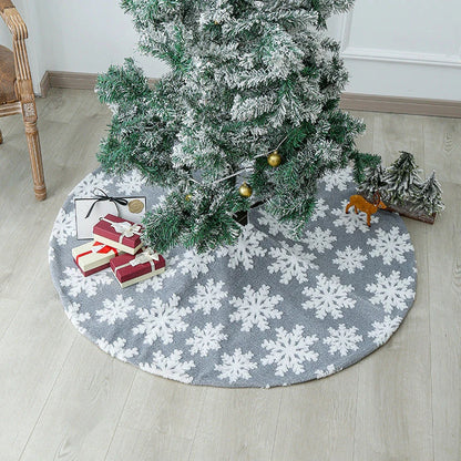 Elegant Christmas tree skirt with plush snowflake design, creating a cozy and festive holiday atmosphere.