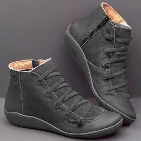 Women's casual booties with wedge heel and round toe in various colours like black and leopard print, showing rubber sole.