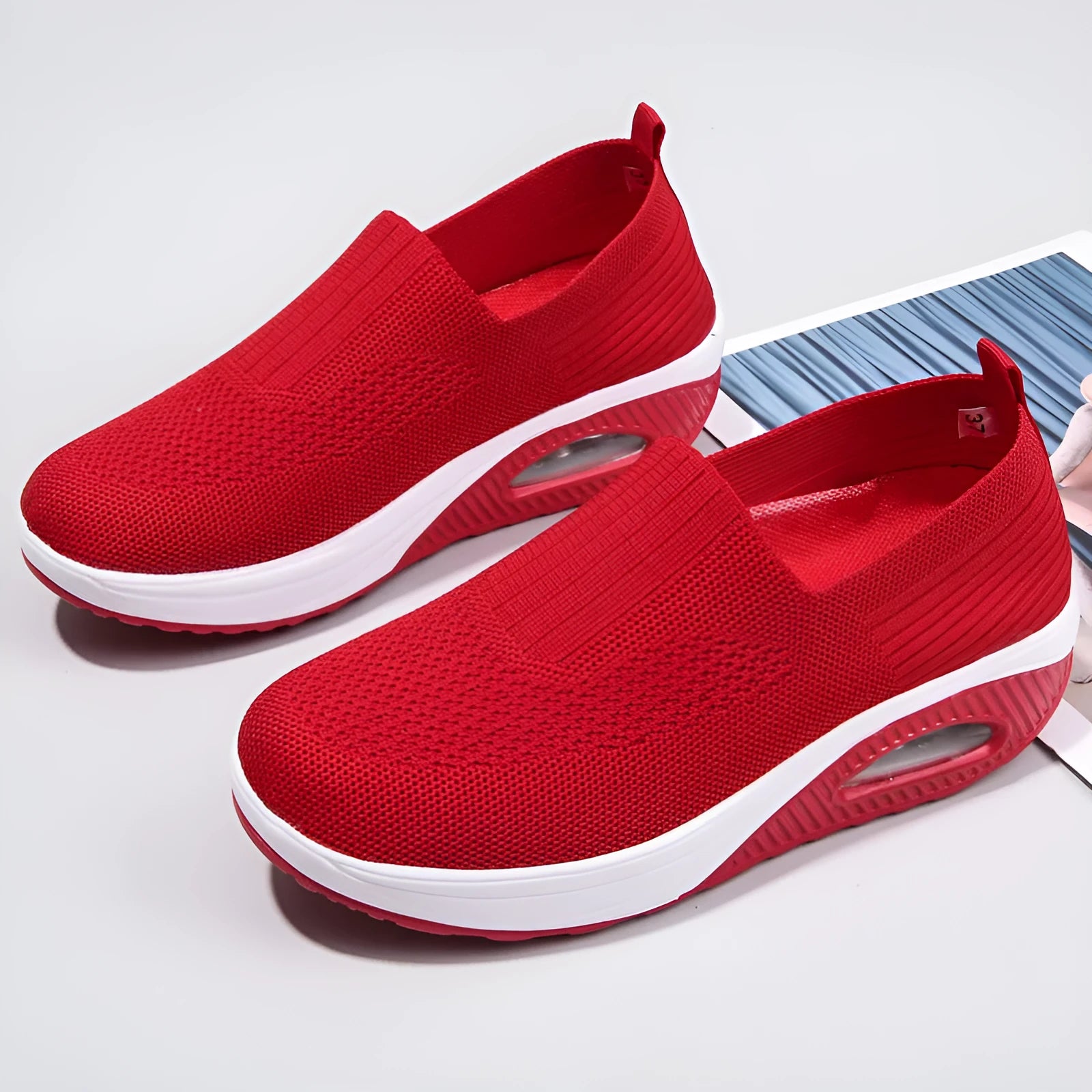 Women's beige mesh running shoes with round toe and air cushion midsole on a grey background.