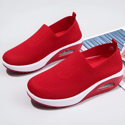 Women's beige mesh running shoes with round toe and air cushion midsole on a grey background.