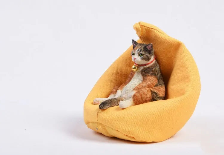 Lazy cat ornament on miniature sofa for car dashboard decoration, 7.5cm high with fabric art detailing