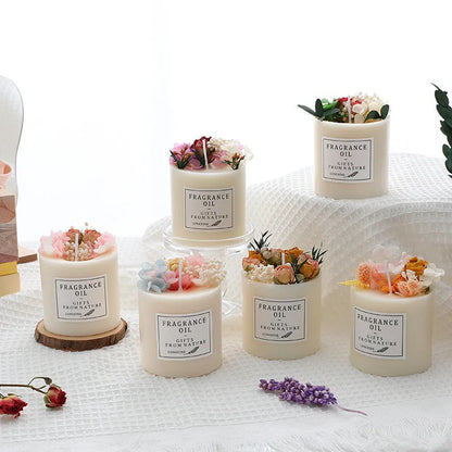Aromatherapy candle with dried flowers decoration on a wooden chip base.