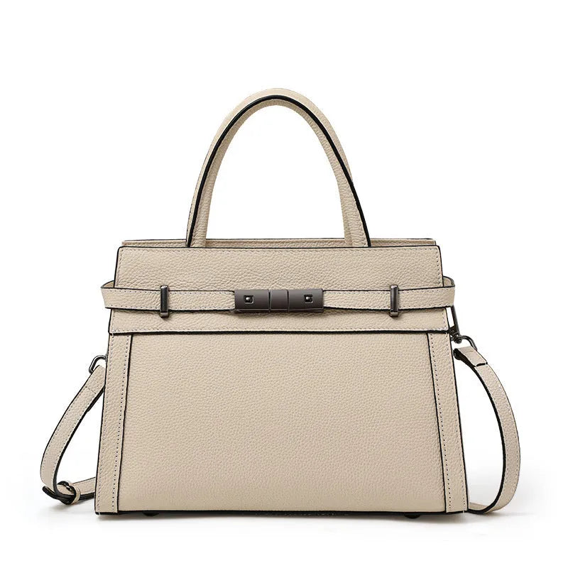 Women's square genuine leather crossbody handbag in clamshell style with internal compartments.