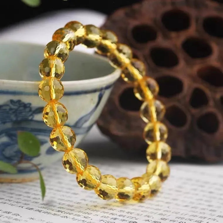 Handmade crystal bracelet with 128-cut gemstone beads and zodiac charm on wrist