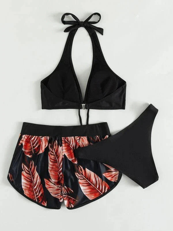 A stylish 3-piece swimsuit set featuring a unique leaf print design, including a top, bottoms, and matching shorts.