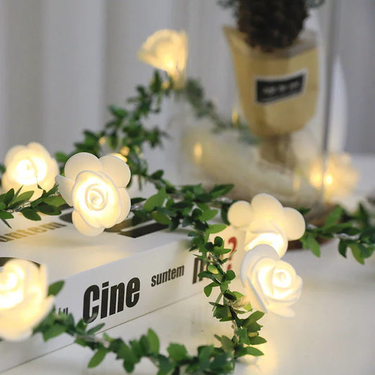 Enchanting rose vine string lights with warm white LED illumination and natural green leaves and rose buds
