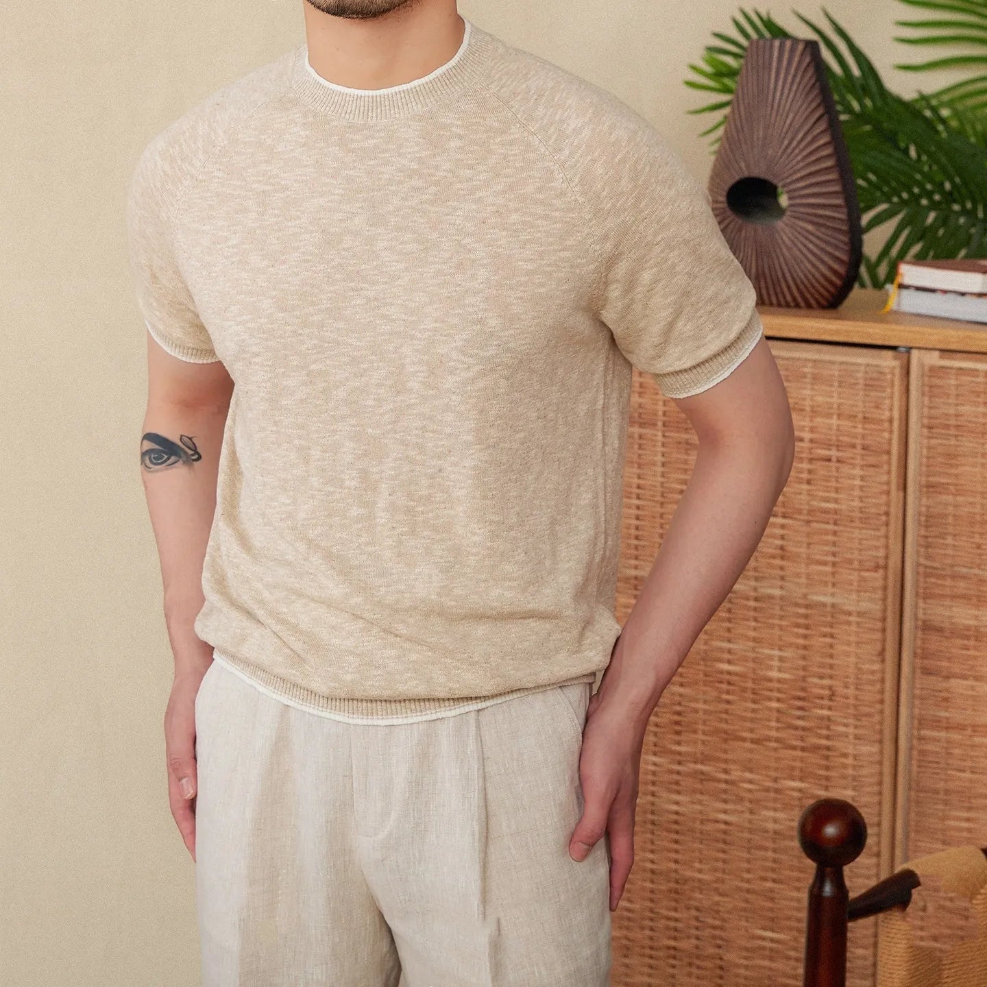 Brown linen-cotton blend short sleeve t-shirt with round neck on a hanger.