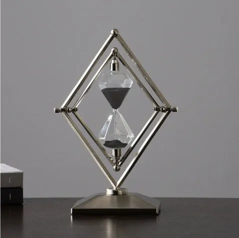 Glass sand timer with zinc alloy metal ornaments in bronze or silver colours, showing sand flow for timing.
