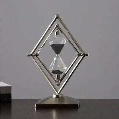 Glass sand timer with zinc alloy metal ornaments in bronze or silver colours, showing sand flow for timing.