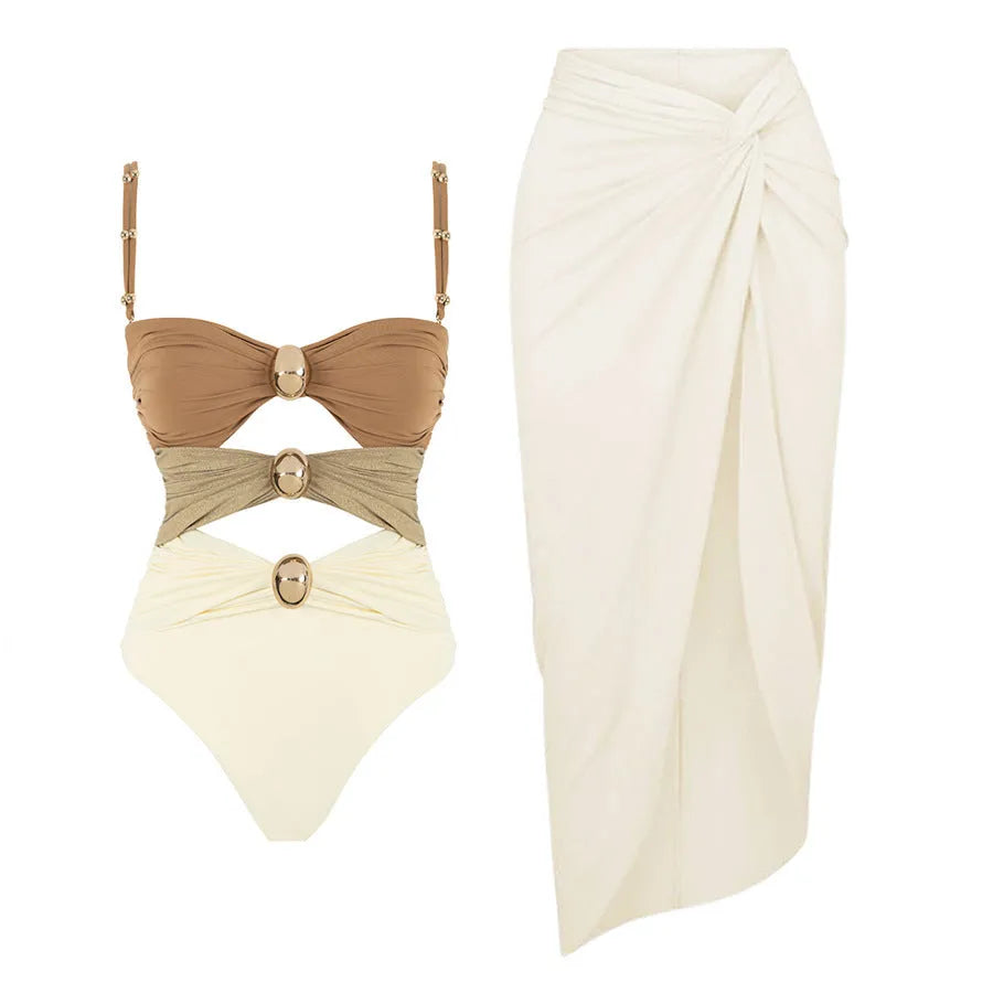 A woman's solid-colour one-piece swimsuit with a gold button detail and an attached matching skirt.