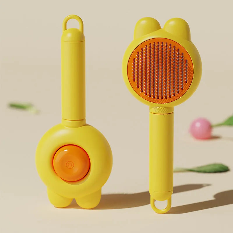 Green self-cleaning pet grooming brush with a release button and rubber-tipped metal pins on a non-slip handle.
