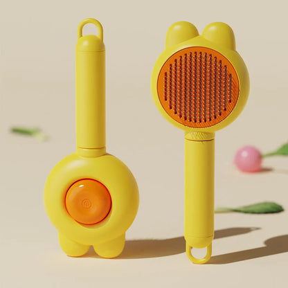 Green self-cleaning pet grooming brush with a release button and rubber-tipped metal pins on a non-slip handle.