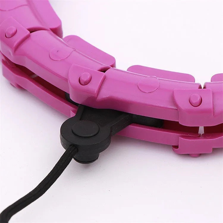 Pink massage soft ball with a detachable black belt, shown on a fitness mat.