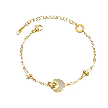 Stainless steel bracelet with double-layer heart design containing resin elements, shown on wrist