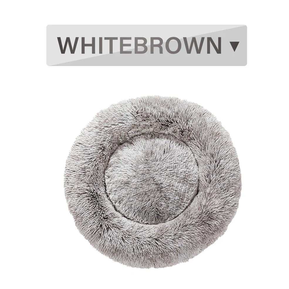 Fluffy donut-shaped dog bed in dark grey colour with raised edges, showing plush texture and circular design