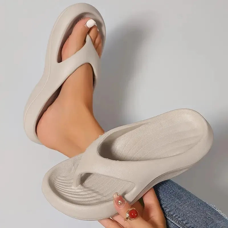 Women's black thick-soled EVA flip-flops with a non-slip pattern on the sole.