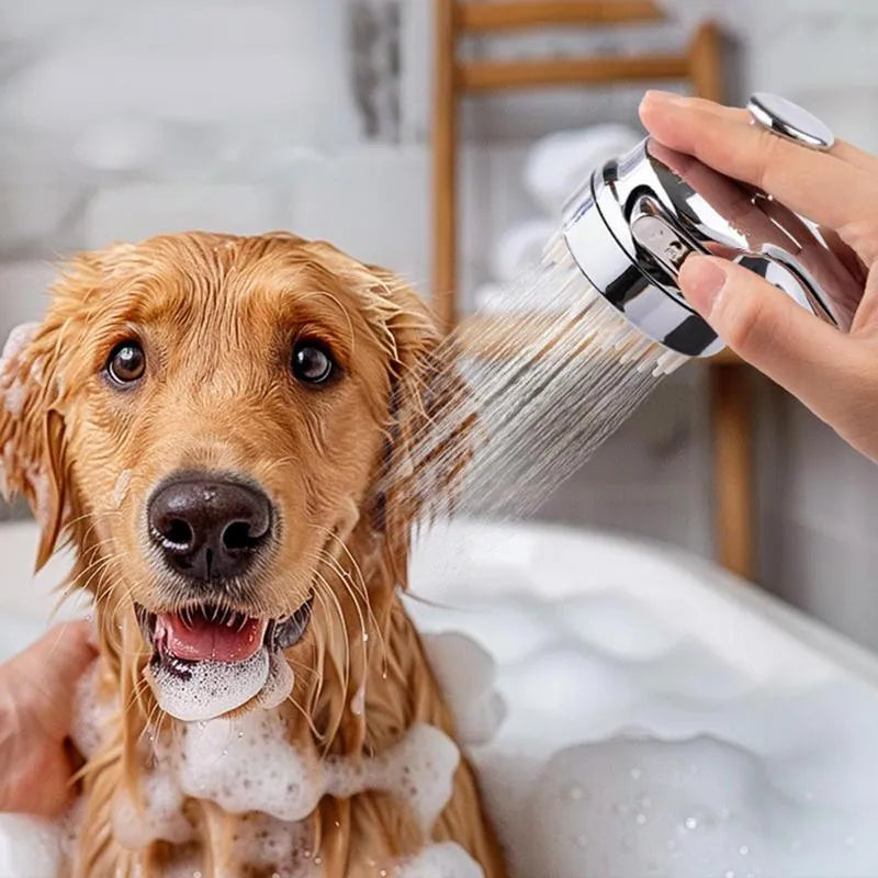 Silver dog shower attachment with silicone comb teeth and ergonomic grip for pet bathing.