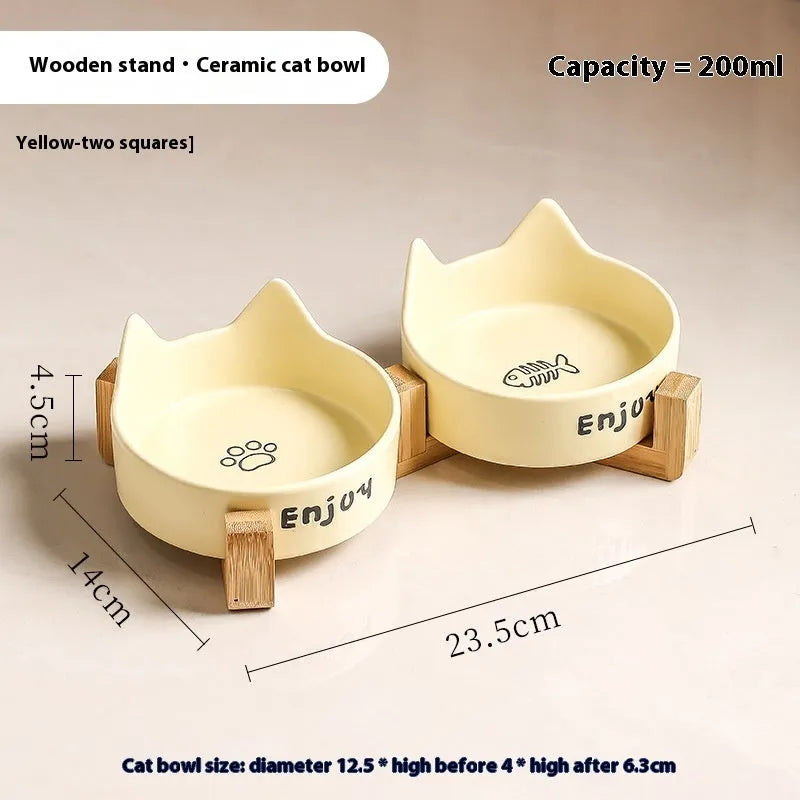 Porcelain cat bowl with anti-tumble wooden frame in pink with a cat paw design
