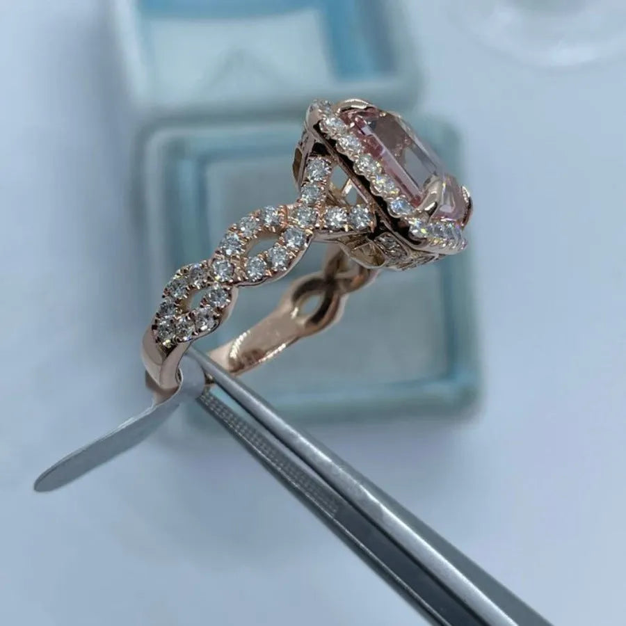 Rose gold electroplated geometric alloy ring on a white background.