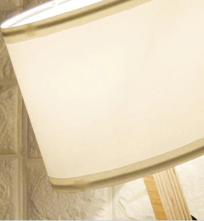 Humanoid wooden table lamp with deformable design and fabric shade for modern home decor