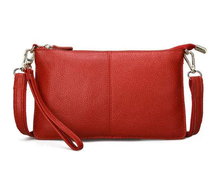 Lady's cowhide slant bag in apricot colour showing front view with strap and compact 24 cm size.