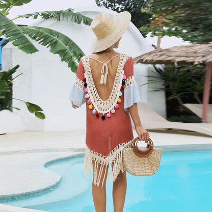 Orange floral pattern beach overskirt with white crochet stitching and long tassels.
