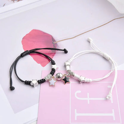 Magnetic suction couple bracelet pair in alloy with an electroplated finish, showing example designs like a crown and love lock.