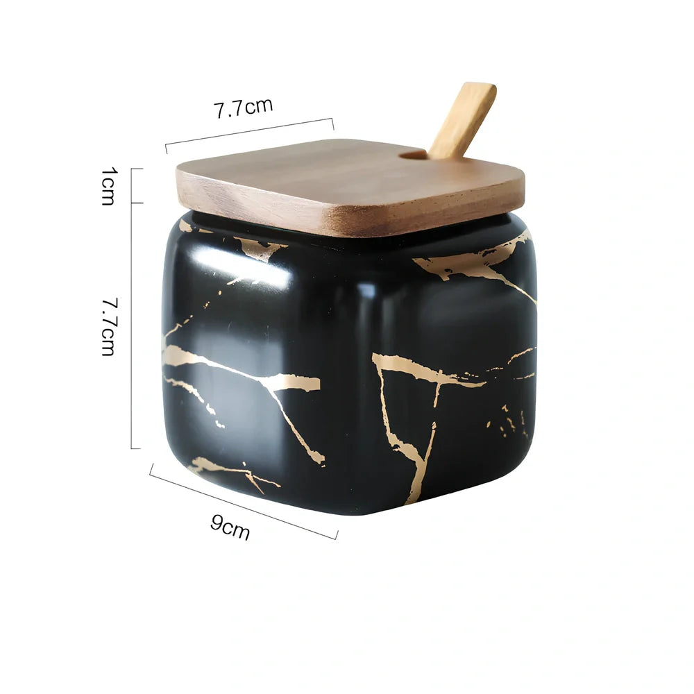 Three-piece Nordic Gold Marble Jar Set in white ceramic with wooden tray and bamboo spoons on kitchen counter