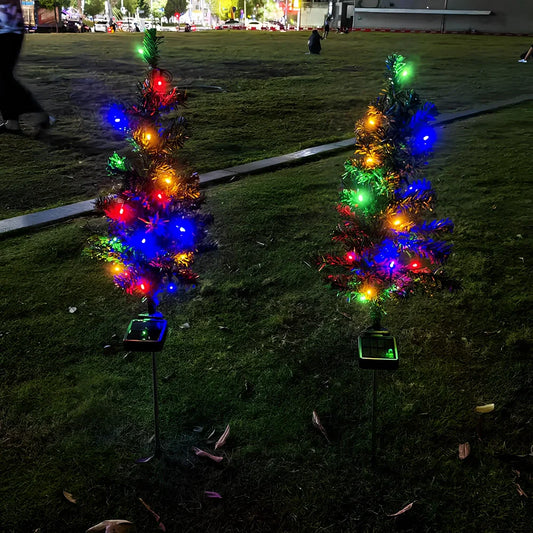 Solar-powered Christmas tree garden light with green ABS construction and warm white LED illumination