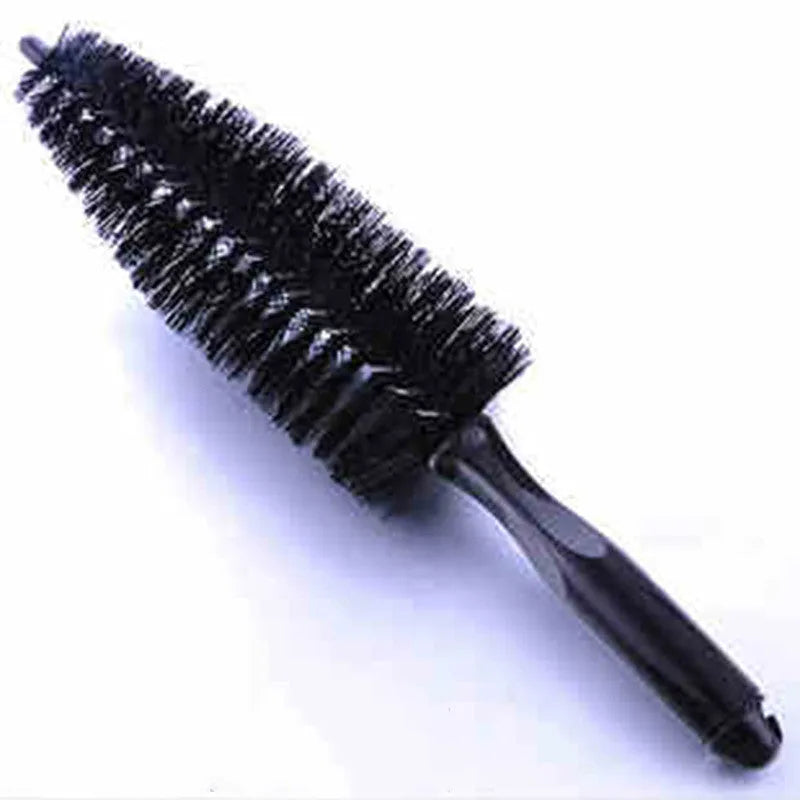 Car tire wheel brush with long handle and twisted yarn bristles for wheel hub cleaning.